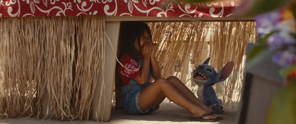 Maia Kealoha hiding under a table with Stitch
