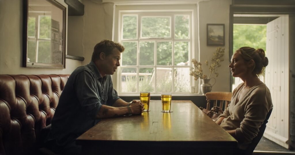 BRAD PITT as Sonny Hayes and KERRY CONDON as Kate.